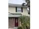Inviting townhouse with a red front door, brick facade, and lush palm trees at 1432 Highway 544 # B2, Conway, SC 29526