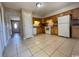 Functional kitchen featuring wood cabinets, tile floors, and a bright entryway at 1432 Highway 544 # B2, Conway, SC 29526