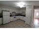 Kitchen featuring white cabinets, black countertops, and white appliances at 1432 Highway 544 # B2, Conway, SC 29526
