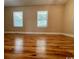 Spacious main bedroom with natural light, two windows, and hardwood flooring at 1432 Highway 544 # B2, Conway, SC 29526