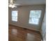 Cozy bedroom with ceiling fan, two windows offering natural light and hardwood-style floors at 1432 Highway 544 # B7, Conway, SC 29526