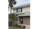 Charming two-story townhouse with brick accents, complemented by lush palm trees and a welcoming front door at 1432 Highway 544 # B7, Conway, SC 29526