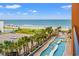 Balcony view of ocean, beach, parking lot, and lazy river pool on a sunny day with clear blue sky at 1501 S Ocean Blvd. # 501, Myrtle Beach, SC 29577