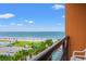 Balcony view of ocean, beach, cars, and pool on a sunny day with clear blue sky at 1501 S Ocean Blvd. # 501, Myrtle Beach, SC 29577