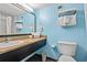Bathroom featuring granite countertop, large mirror, toilet, and towel rack at 1501 S Ocean Blvd. # 501, Myrtle Beach, SC 29577