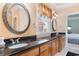 This bathroom features a double vanity with granite countertops, decorative mirrors, and a view to the bedroom at 1516 James Island Ave., North Myrtle Beach, SC 29582