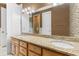 Bathroom with double sinks, granite countertops, wood cabinets, and decorative tile at 1516 James Island Ave., North Myrtle Beach, SC 29582