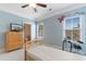 This bedroom features a twin bed, neutral carpet, and large windows to the ensuite bathroom at 1516 James Island Ave., North Myrtle Beach, SC 29582