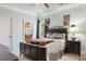 This bedroom features a large bed with decorative pillows, dark wood furniture, and an ensuite bath at 1516 James Island Ave., North Myrtle Beach, SC 29582