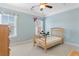 This bedroom features a twin bed, neutral carpet, and large windows to the outside at 1516 James Island Ave., North Myrtle Beach, SC 29582