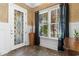 Welcoming entryway featuring a decorative glass door and a large window with sheer curtains at 1516 James Island Ave., North Myrtle Beach, SC 29582