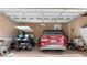 Spacious garage with a parked golf cart and a red SUV provides ample storage at 1516 James Island Ave., North Myrtle Beach, SC 29582
