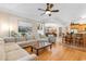 Open concept living room with hardwood floors, sectional sofa, and view of the kitchen and dining area at 1516 James Island Ave., North Myrtle Beach, SC 29582