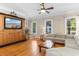 Bright living room with hardwood floors, a ceiling fan, and a large sectional sofa with natural light at 1516 James Island Ave., North Myrtle Beach, SC 29582