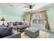 This living room features neutral tones, wainscotting, a ceiling fan, and lots of seating at 1516 James Island Ave., North Myrtle Beach, SC 29582