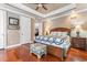 Inviting main bedroom with hardwood floors, a decorative comforter, and a tray ceiling at 1516 James Island Ave., North Myrtle Beach, SC 29582