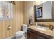 A half bathroom with decorative walls, a granite vanity, and an ornate mirror at 1516 James Island Ave., North Myrtle Beach, SC 29582