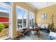 The sunroom with large windows, cozy seating, and tiled floor provides an inviting space at 1516 James Island Ave., North Myrtle Beach, SC 29582