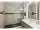 This elegant bathroom features a glass shower stall, a sleek black shower head, and designer tiling at 1622 Havens Dr., North Myrtle Beach, SC 29582