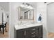 The renovated bathroom features a dual sink vanity with gold hardware and a large mirror at 1622 Havens Dr., North Myrtle Beach, SC 29582