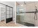 This bathroom features a glass shower stall, a sleek black shower head, and a storage closet at 1622 Havens Dr., North Myrtle Beach, SC 29582