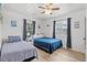 Comfortable bedroom featuring two beds, a ceiling fan, and natural light from the two windows at 1622 Havens Dr., North Myrtle Beach, SC 29582