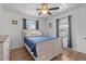 Cozy bedroom featuring a queen bed, a ceiling fan, and soft natural light from the two windows at 1622 Havens Dr., North Myrtle Beach, SC 29582