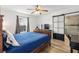 This bright bedroom features a ceiling fan, television, and easy access to the bathroom through a sliding door at 1622 Havens Dr., North Myrtle Beach, SC 29582