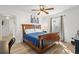 A comfortable bedroom is furnished with a wooden bed frame, a window, and a ceiling fan at 1622 Havens Dr., North Myrtle Beach, SC 29582