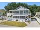 Charming two-story home featuring double balconies, a screened-in porch, and a well-manicured lawn at 1622 Havens Dr., North Myrtle Beach, SC 29582
