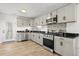 Modern kitchen featuring stainless steel appliances, granite countertops, and ample cabinet space at 1622 Havens Dr., North Myrtle Beach, SC 29582