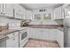 Efficient kitchen with white cabinetry, essential appliances, and a sunny window over the sink at 1622 Havens Dr., North Myrtle Beach, SC 29582