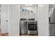 Convenient laundry area featuring modern washer and dryer units and shelving for storage at 1622 Havens Dr., North Myrtle Beach, SC 29582