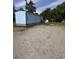 Light blue house with white trim, brick foundation, landscaped garden, and rear entrance at 1659 Sw Beach Dr., Sunset Beach, NC 28468