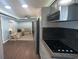 Open concept kitchen with modern appliances, wood floors, and a view of the living room at 1659 Sw Beach Dr., Sunset Beach, NC 28468