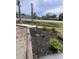 New mulch bed with small plants and palms next to a paved road at 1659 Sw Beach Dr., Sunset Beach, NC 28468