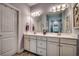 Bathroom featuring a large mirror, double sinks, and white cabinets at 1903 Francis Ct., Myrtle Beach, SC 29577