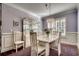 Bright dining room with a modern chandelier, white furnishings, and wainscoting at 1903 Francis Ct., Myrtle Beach, SC 29577