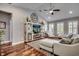 Bright living room with high ceilings, ceiling fan, hardwood floors, and a plush sofa at 1903 Francis Ct., Myrtle Beach, SC 29577