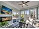 Bright sunroom boasts a modern fireplace, ceiling fan and sliding glass doors to the patio at 1903 Francis Ct., Myrtle Beach, SC 29577