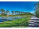 Picturesque view of a calm pond with trees on opposite bank, adjacent to walking path at 1903 Francis Ct., Myrtle Beach, SC 29577
