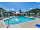 Resort-style pool area with plenty of lounge chairs and a beautiful clubhouse at 1903 Francis Ct., Myrtle Beach, SC 29577
