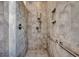 Walk-in shower features attractive neutral tile, built-in shelving and grab bars at 1903 Francis Ct., Myrtle Beach, SC 29577