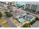 Aerial view of a multi-colored home with a swimming pool, street view and parking at 2102 S Ocean Blvd. # D, North Myrtle Beach, SC 29582