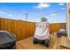 Cozy backyard wooden patio area with a covered golf cart and outdoor seating at 2102 S Ocean Blvd. # D, North Myrtle Beach, SC 29582