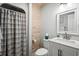 Bathroom features a shower with tub, wood paneled wall, toilet, and vanity sink at 2102 S Ocean Blvd. # D, North Myrtle Beach, SC 29582