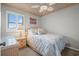 Bedroom with wicker furniture, ceiling fan, and bright natural light at 2102 S Ocean Blvd. # D, North Myrtle Beach, SC 29582