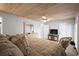 Comfortable bedroom features a wood plank ceiling, ceiling fan, and cozy furniture at 2102 S Ocean Blvd. # D, North Myrtle Beach, SC 29582