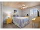 Bedroom features ceiling fan, bright natural light, and side tables at 2102 S Ocean Blvd. # D, North Myrtle Beach, SC 29582