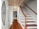 Bright entryway with hardwood floors, staircase, and wood ceiling, offering a welcoming entrance at 2102 S Ocean Blvd. # D, North Myrtle Beach, SC 29582